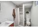 Bathroom featuring a shower with white marbled tiles at 11600 W 31St Pl, Lakewood, CO 80215