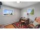 Serene bedroom with natural light, hardwood floors, and a dedicated desk space for work or study at 11600 W 31St Pl, Lakewood, CO 80215