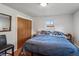 Bedroom with a wooden closet, window, and neutral decor at 11600 W 31St Pl, Lakewood, CO 80215