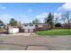 Charming split-level home featuring a two-car garage, brick accents, and a well-maintained front lawn at 11600 W 31St Pl, Lakewood, CO 80215