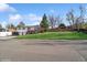 A well-maintained split-level home with a spacious front yard and mature trees providing shade and curb appeal at 11600 W 31St Pl, Lakewood, CO 80215