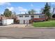 Charming split-level home featuring a two-car garage, brick accents, and a well-maintained front lawn at 11600 W 31St Pl, Lakewood, CO 80215