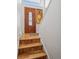 Inviting foyer with hardwood floors, decorative front door, and staircase leading to the upper level at 11600 W 31St Pl, Lakewood, CO 80215