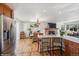 Open floor plan showcasing a modern kitchen with a breakfast bar flowing into a dining area and living space at 11600 W 31St Pl, Lakewood, CO 80215