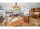 Open concept living room and dining area with hardwood floors and large windows overlooking the yard at 11600 W 31St Pl, Lakewood, CO 80215