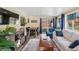 Inviting living room with wood-look flooring, backyard access, and an adjacent dining space at 11600 W 31St Pl, Lakewood, CO 80215
