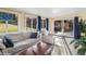 Bright sunroom offering a serene view of the outdoor space through multiple windows and glass doors at 11600 W 31St Pl, Lakewood, CO 80215