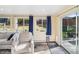 Comfortable sunroom featuring natural light, access to the deck, and stylish decor at 11600 W 31St Pl, Lakewood, CO 80215