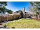 Landscaped backyard featuring a lawn, wooden fence, stone accents, and a patio area at 789 Zamia Ave, Boulder, CO 80304