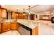 Granite countertop wet bar with custom cabinetry in finished basement with fireplace and open floor plan at 789 Zamia Ave, Boulder, CO 80304