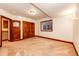 Open carpeted basement featuring wood trim, double doors, and natural light at 789 Zamia Ave, Boulder, CO 80304