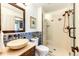 Bathroom featuring a vessel sink, wood accents, a framed mirror and a tiled glass shower enclosure at 789 Zamia Ave, Boulder, CO 80304