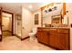 Modern bathroom with wood vanity, granite countertop, and glass enclosed shower at 789 Zamia Ave, Boulder, CO 80304