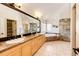 A bathroom with double sinks, granite counters, large mirror, soaking tub and tile shower at 789 Zamia Ave, Boulder, CO 80304