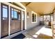 Inviting front porch featuring a dark wood door, stone accents, and ample natural light, creating a warm welcome at 789 Zamia Ave, Boulder, CO 80304