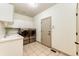 Functional laundry room with washer, dryer, utility sink and ample storage space at 789 Zamia Ave, Boulder, CO 80304