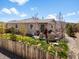 Expansive backyard with a covered patio, lush lawn, and privacy fence at 1694 Castle Vista Way, Castle Rock, CO 80104