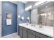 Modern bathroom features double sinks, stylish fixtures, and elegant mirror creates a spa-like experience at 1694 Castle Vista Way, Castle Rock, CO 80104
