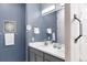 This modern bathroom features double sinks and an elegant mirror for a spa-like experience at 1694 Castle Vista Way, Castle Rock, CO 80104