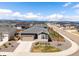 Aerial shot of a single-Gathering home in a neighborhood with mountain views, blue skies, and green lawns at 1694 Castle Vista Way, Castle Rock, CO 80104