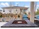 Inviting fire pit area with comfortable outdoor seating and serene backyard view at 1694 Castle Vista Way, Castle Rock, CO 80104