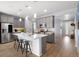 Bright kitchen with large island, stainless steel appliances, pendant lighting, and wood floors at 1694 Castle Vista Way, Castle Rock, CO 80104