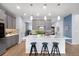 Modern kitchen with white countertops, gray cabinets, stainless appliances, and bar stool seating at 1694 Castle Vista Way, Castle Rock, CO 80104