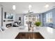 Open concept living room with fireplace, large windows, modern furniture, and stylish decor at 1694 Castle Vista Way, Castle Rock, CO 80104