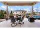 Covered patio with outdoor furniture, perfect for relaxation and entertaining with green grass and trees at 1694 Castle Vista Way, Castle Rock, CO 80104
