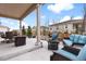 Relaxing patio with ample seating, fire pit, and well-maintained outdoor space at 1694 Castle Vista Way, Castle Rock, CO 80104