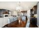 Open concept dining area with kitchen views and hardwood floors at 7800 E 148Th Dr, Thornton, CO 80602