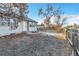 Fenced backyard with a grassy area and a view of a neighboring home at 740 Fulton Ave, Fort Lupton, CO 80621