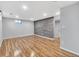 Spacious finished basement with wood-look flooring and accent wall at 740 Fulton Ave, Fort Lupton, CO 80621