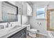 Clean bathroom with a vanity, toilet, shower/tub, and window at 740 Fulton Ave, Fort Lupton, CO 80621