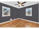 Bedroom with hardwood floors, ceiling fan and gray walls at 740 Fulton Ave, Fort Lupton, CO 80621