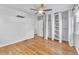 Bedroom with hardwood floors, ceiling fan, and built-in shelving at 740 Fulton Ave, Fort Lupton, CO 80621