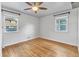 Spacious bedroom with hardwood floors, ceiling fan, and two windows at 740 Fulton Ave, Fort Lupton, CO 80621