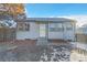 Cute ranch home with gray exterior, landscaping, and a fenced yard at 740 Fulton Ave, Fort Lupton, CO 80621