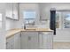 Modern kitchen with gray cabinets, butcher block countertops, and stainless steel appliances at 740 Fulton Ave, Fort Lupton, CO 80621