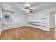 Bright living room featuring hardwood floors, built-in shelving, and a ceiling fan at 740 Fulton Ave, Fort Lupton, CO 80621