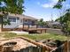 Backyard featuring deck, landscaping, fire pit, and garden at 2155 S Deframe St, Lakewood, CO 80228