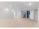 Large basement with neutral carpeting and access to the stairs and laundry area at 2155 S Deframe St, Lakewood, CO 80228