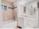 This bathroom includes a tiled shower/tub and a decorative vanity with mosaic accents at 2155 S Deframe St, Lakewood, CO 80228