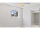 Bright bedroom features a window, ceiling fan, and mirrored closet at 2155 S Deframe St, Lakewood, CO 80228