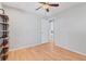 Bright bedroom featuring hardwood floors, modern ceiling fan, and a stylish industrial shelving unit at 2155 S Deframe St, Lakewood, CO 80228