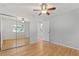 This comfortable bedroom features natural light, hardwood floors, and a mirrored closet at 2155 S Deframe St, Lakewood, CO 80228