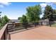 Beautiful deck surrounded by greenery and mature trees at 2155 S Deframe St, Lakewood, CO 80228