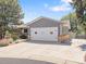 Single-story home featuring a two-car garage, blue siding, white trim, and a well-maintained yard at 2155 S Deframe St, Lakewood, CO 80228