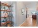 Hallway leading to the recently renovated kitchen with modern appliances and granite countertops at 2155 S Deframe St, Lakewood, CO 80228