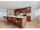 Beautiful kitchen featuring cherry wood cabinets, granite countertops, stainless appliances, and seating at the island at 2155 S Deframe St, Lakewood, CO 80228